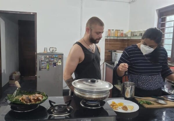A cooking demonstration in Alleppey, Kerala, as part of a food tour, where traditional Kerala dishes are being prepared, showcasing the region's rich culinary traditions.